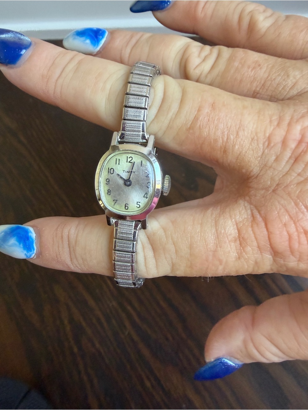 Vintage Timex Watch with an oval silver-tone dial and a flexible expansion band